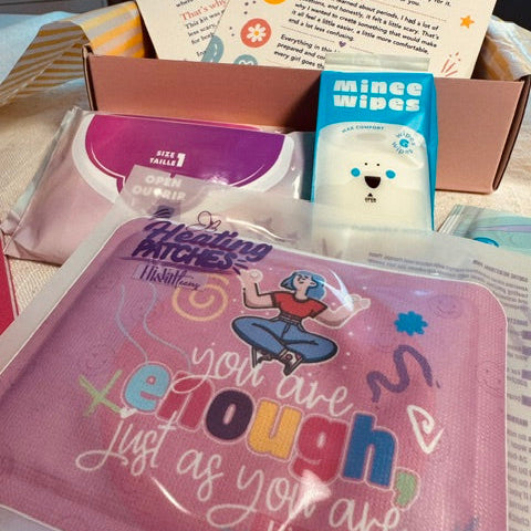 A curated wellness gift box with a heat patch with the quote 'You are enough' affirmation